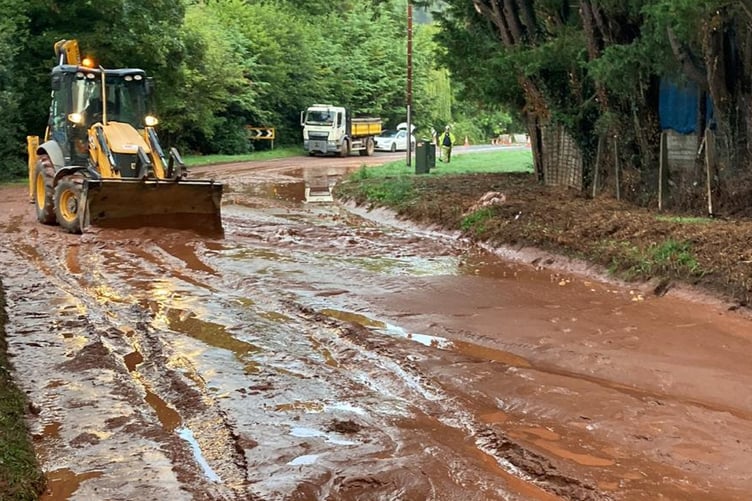 The flooded A358 near Combe Florey, Somerset - caused by a potato field mudslide. See SWNS story SWMRmud. Highway workers are seen in a clear-up operation after flash floods cause a potato field to collapse and swamp a road.The A358 near Combe Florey, Somerset, just outside Bishops Lydeard and near Taunton, has been shut with a diversion route in place.  Somerset County Council has a highways team at the scene, who are using diggers in an attempt to clear the extensive sludge covering the roads.Somerset County Council - @TravelSomerset - posted the images at 7:12am this morning (6 September), writing: "Here's the scene on the A358 at Combe Florey this morning after last night's mudslide.