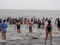 New Year swimmers brave downpours for fundraising dip at Minehead