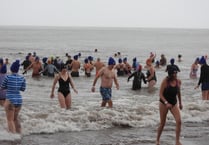 New Year swimmers brave downpours for fundraising dip at Minehead
