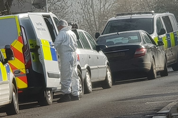 A person in a white protective suit in Jurston Lane, Wellington