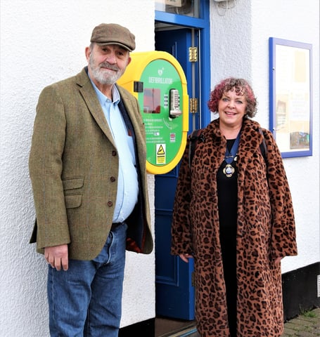 Alex Reynard with the mayor, Cllr Olivia Campbell, with the reinstated defibrillator
