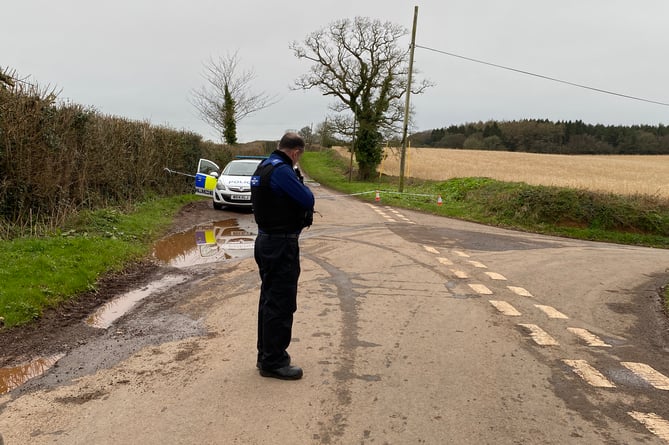 A PCSO seen manning a cordon at the junction with Rose Hill and an unnamed country road
