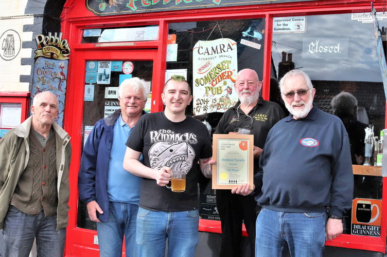 Dean Manley, manager of Pebbles Tavern, receives his certificate from Phil Evans, social secretary of CAMRA (Somerset Branch)