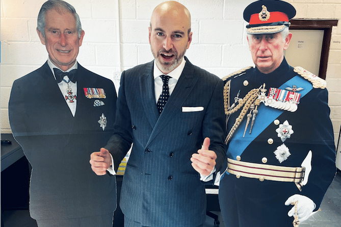 Porlock First Graphic Design boss Mark Padgett (centre) with the two life-size images of King Charles III coronation
