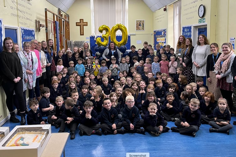 Pupils and staff of Old Cleeve First School help celebrate Kirsty Cornish's 30 years of service with Teddy Bears Pre-school