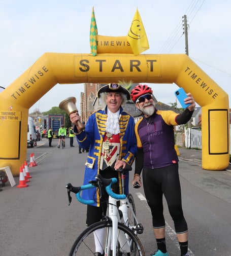 Coast to coast cycle: One cyclist takes the opportunity to take a selfie with town crier David Milton  