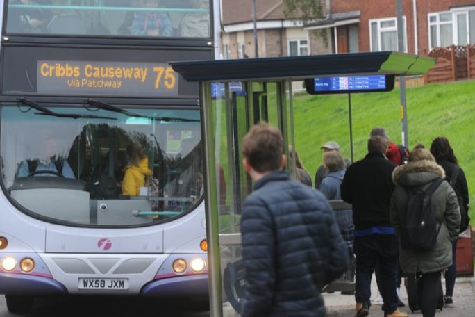 Young people using a bus.