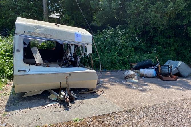 Vandals torched a garage before returning to attack a caravan 