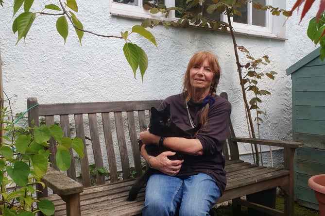 Pam Leach with her cat 'Rishi', who faces eviction from her rented home in Porlock.