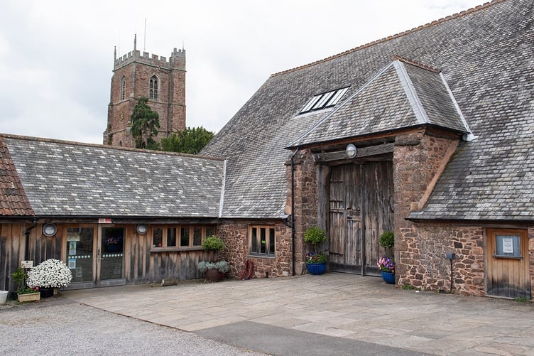 Dunster Tithe Barn with St George's Church just behind it.