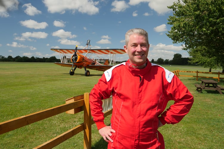 Mike Davies, from Hinkley Point B, preparing for a wing walk stunt on the biplane seen in the background to raise money for a cancer charity.