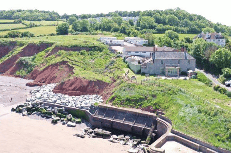 The Anchors Drop pub in Blue Anchor with caravans behind.