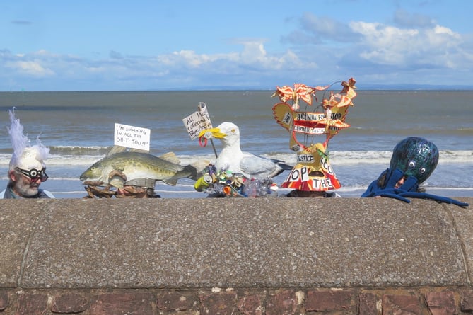 Effigies of sea creatures affected by raw sewage dumping.