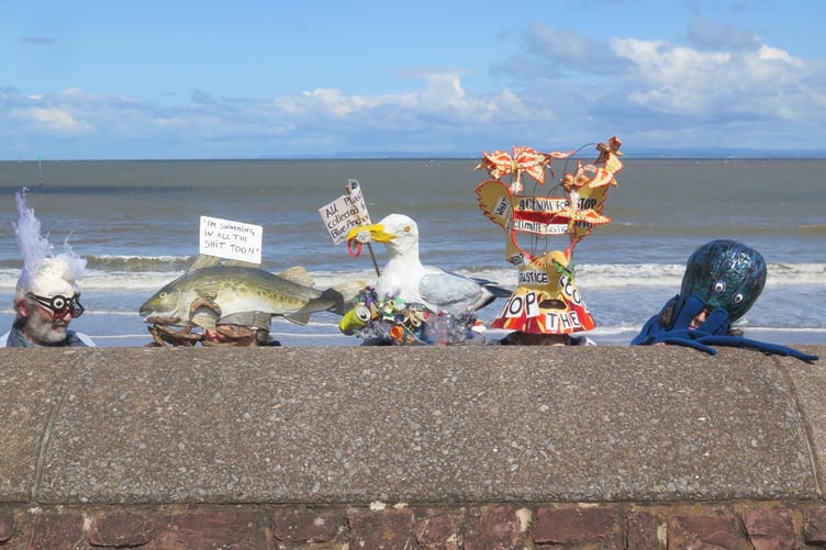 Effigies of sea creatures affected by raw sewage dumping.