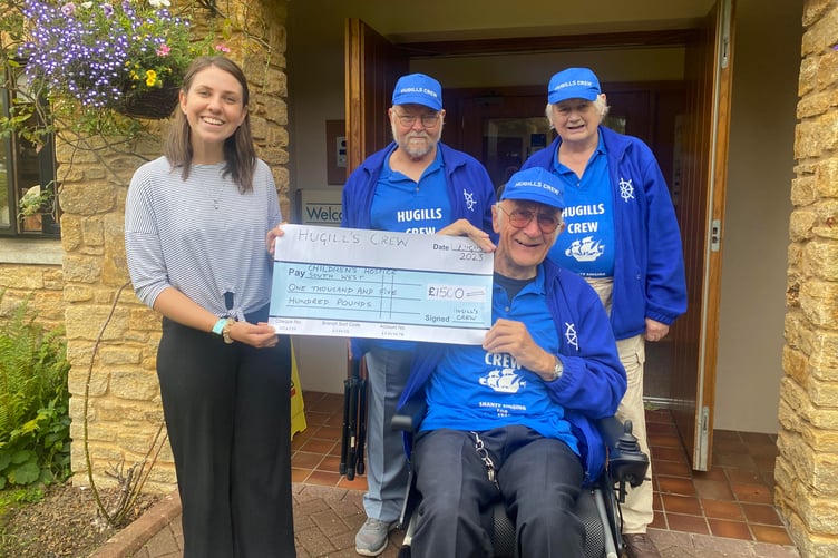 Hugill’s Crew founder Keith Woolgar with fellow singers Raymond Coleing and Mike Dibble presenting a cheque to Children’s Hospice South West area fund-raiser Mary Grey.
