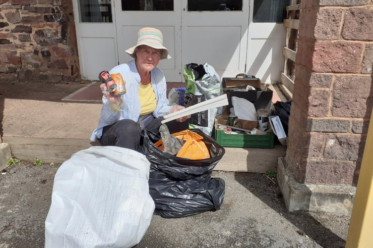 Carhampton Climate Group’s Dorothy Lloyd, who organised the litter pick, sorting bags for recycling.