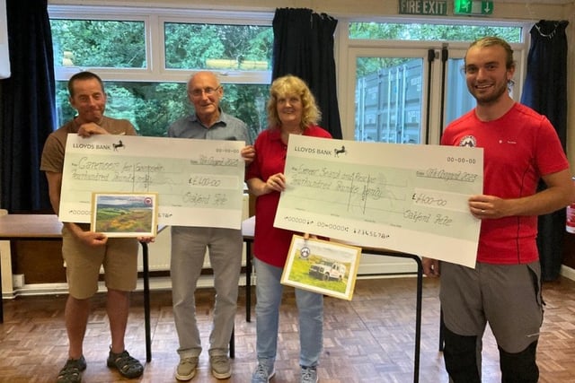Oakford Fete organisers David Bannister and Kelvin Holdom presenting cheques to CareMoor for Exmoor and Exmoor Search and Rescue.