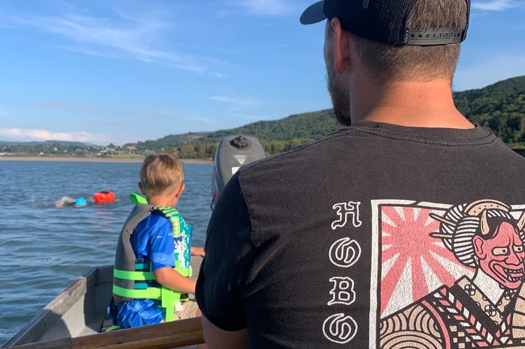 Gemma Allerton's support team shadow her off Porlock Weir as she finishes her 'Channel' swim.