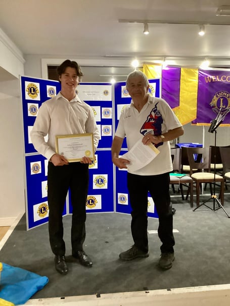 Anthony Knight (left) receiving his young leaders award from Minehead Lions district youth officer Colin Marsh.