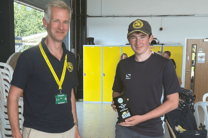 Dorset and Somerset Air Ambulance chief executive Charles Hackett presenting the Hugo Yaxley Trophy to Ben Kilminster.