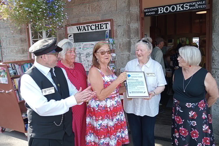 Dementia friends champion Margaret Tatham presenting a certificate to Watchet station master Kathy Jones, watched by railway volunteers Dan and Linda Brown, and Stogursey dementia group leader Rose Chalk.