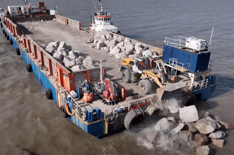 The SeaRock 1 barge offloading granite onto the shore in Minehead.