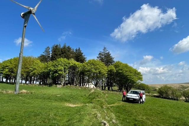 A wind turbine and electric vehicle at Pinkery Outdoor Education Centre, on Exmoor.