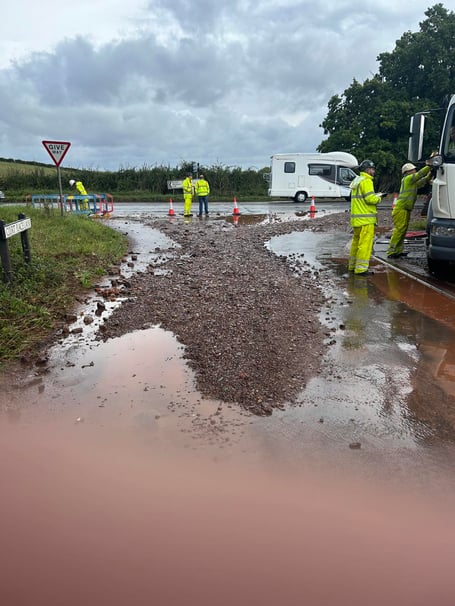 Somerset Council highways teams clearing the flooded B3222 at Riphay, near Dulverton. 