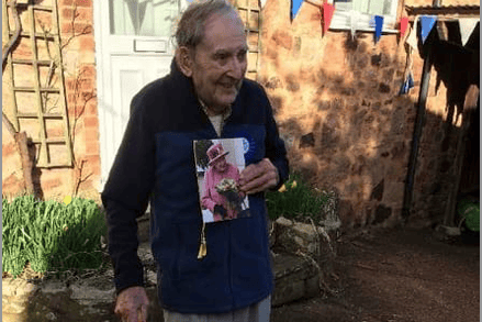 Bob Shire with a card from the Queen congratulating him on reaching 100 years of age.