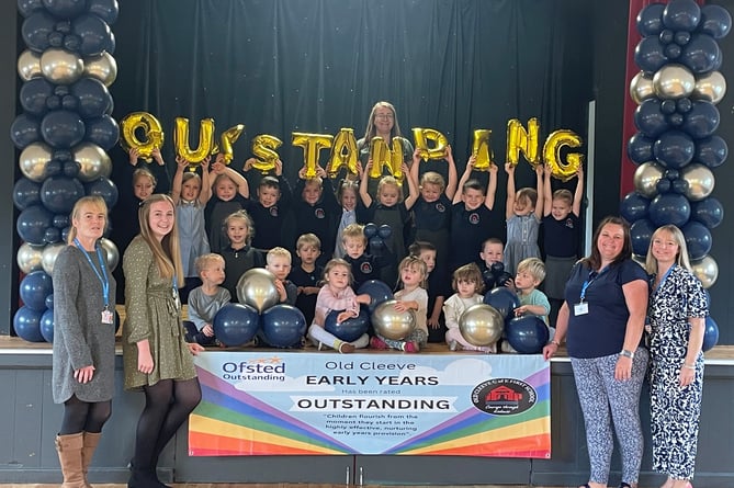 Early years children and staff in Old Cleeve School celebrate an 'outstanding' Ofsted rating.