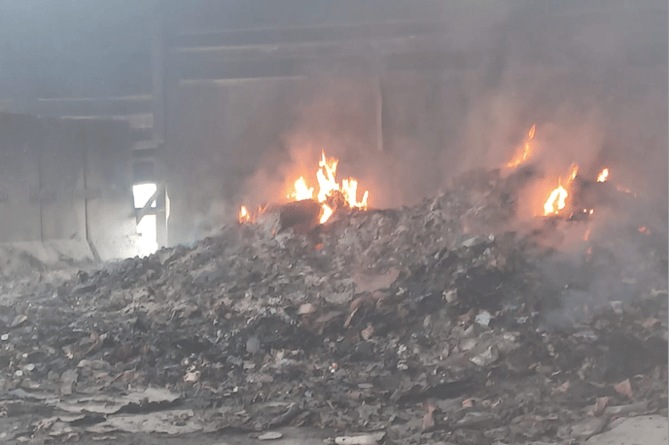 Fire continues to burn in the Taunton recycling centre on Friday.