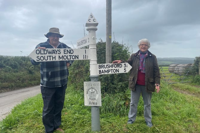 Fingerpost volunteers Jeremy Davies and Margret Rawle. Jeremy hand-painted the cast iron signposts at both ‘12 acre’ and Withypool Cross after they were welded back together by a local company, while Margaret found and reported broken pieces of the ‘12 acre’ signpost near Brushford.