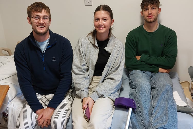Finn Webber (left) being visited in hospital by sister Isobel and brother Sam.