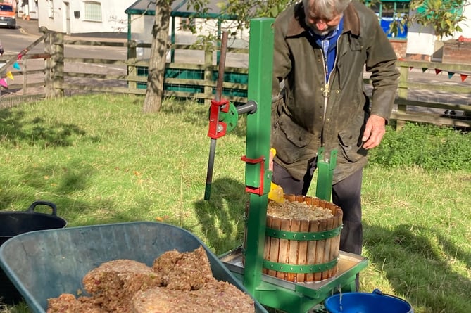 Long-term Carhampton Orchard member Stuart Heesom at the apple press for the village's 'apple day'.