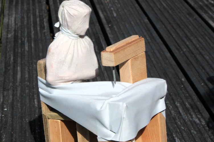 One of the figures depicting a child at a sewing machine.