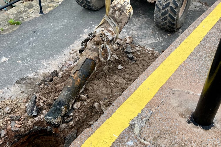 A telehandler is used to haul one of Minehead Harbour's cannons from the ground .