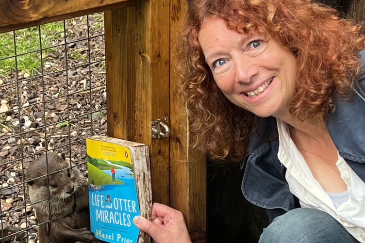 Author Hazel Prior and her new book catching the attention of an otter.