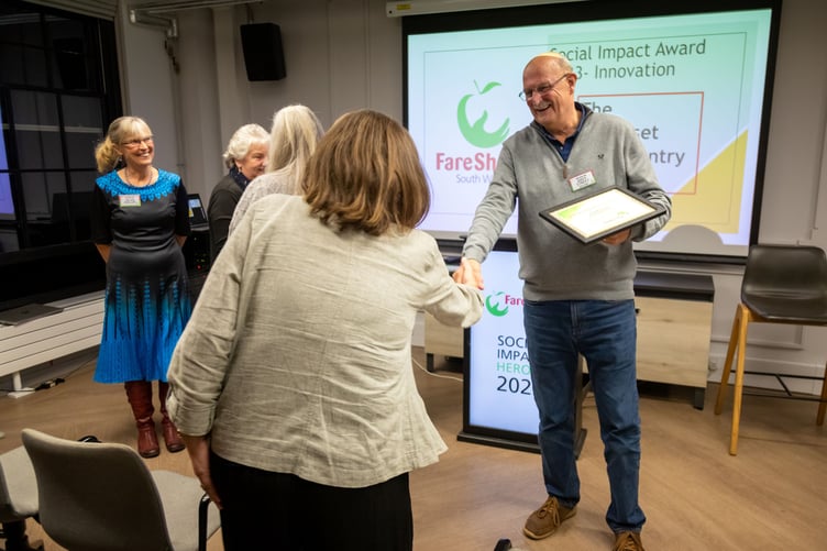 Ali Sanderson, from the Minehead Area Local Pantry, shaking hands with Andy Street, FareShare South West chair of trustees.