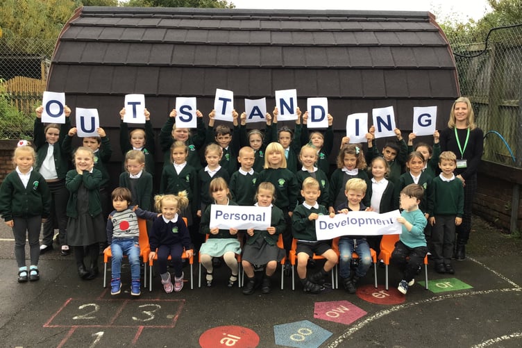 Pupils and staff of Timberscombe Church of England First School celebrate their Ofsted inspection results.
