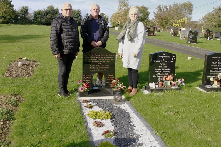 Martin Perkins (centre) with his brother David and sister Linda Howells at their parents' grave in St Decuman's Churchyard, Watchet.