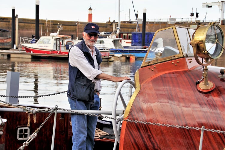 Jonathan Pearman in Watchet Marina at the helm of his restored lifeboat the Elliott Gill.