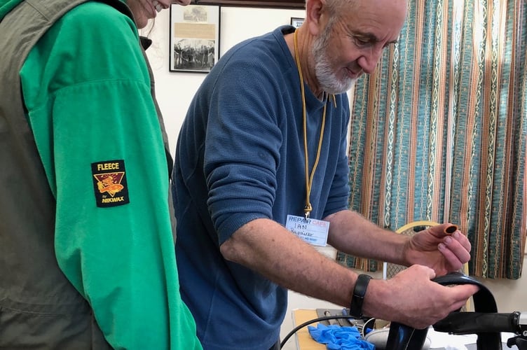 A bicycle tyre puncture being mended at Carhampton Repair Cafe.
