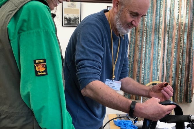 A bicycle tyre puncture being mended at Carhampton Repair Cafe.