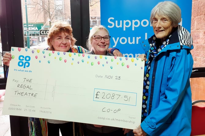 Minehead Regal Theatre chairman Monica Hartwell and Georgina Charnock, from Oasis, receive a cheque from Co-op member pioneer Sarah Burnett.