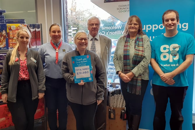 Williton store manager Fay Whitehead, Co-op community member Sarah Burnett, and Liddymore Road Watchet store manager Kevin Dodd present a cheque to Williton War Memorial Ground committee members.