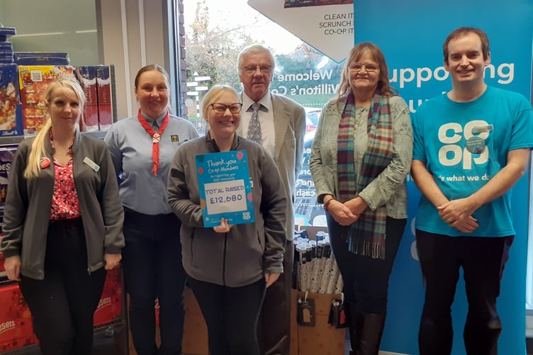Williton store manager Fay Whitehead, Co-op community member Sarah Burnett, and Liddymore Road Watchet store manager Kevin Dodd present a cheque to Williton War Memorial Ground committee members.