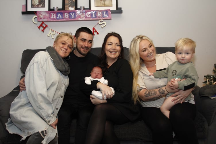 Pictured (left to right) with baby Amelia are nan Jodie Slater, dad Cameron Lawlor, mum Leanne Tighe, best friend and stand-in midwife Ashley Brooke and her son Hudson.