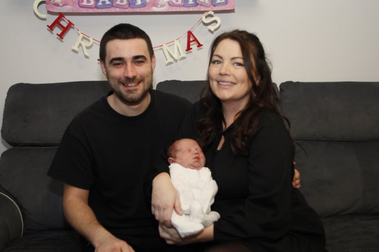 Cameron Lawlor and partner Leanne Tighe with daughter Amelia, who was born under the Christmas tree in their living room.