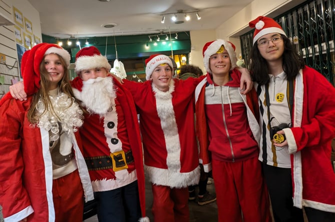 Young environmentalists While We Still Can took part in Porlock's Santa Dash after the success of their pop up Down To Zero shop.