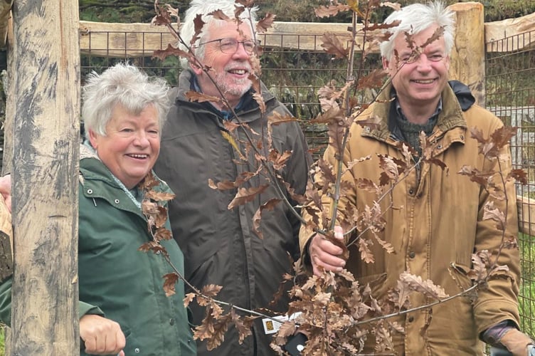 Mark Richards with sister Julia and her husband Steve with Exmoor's first Kings Wood parkland tree sustainable tree guard.